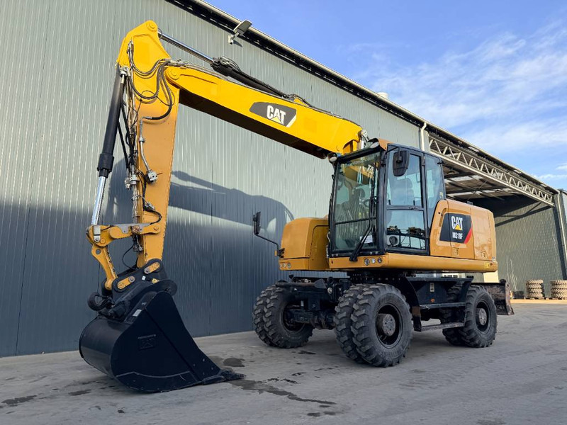 Cat M318F - Pelle sur pneus: photos 1 Cat M318F - Pelle sur pneus: photos 1