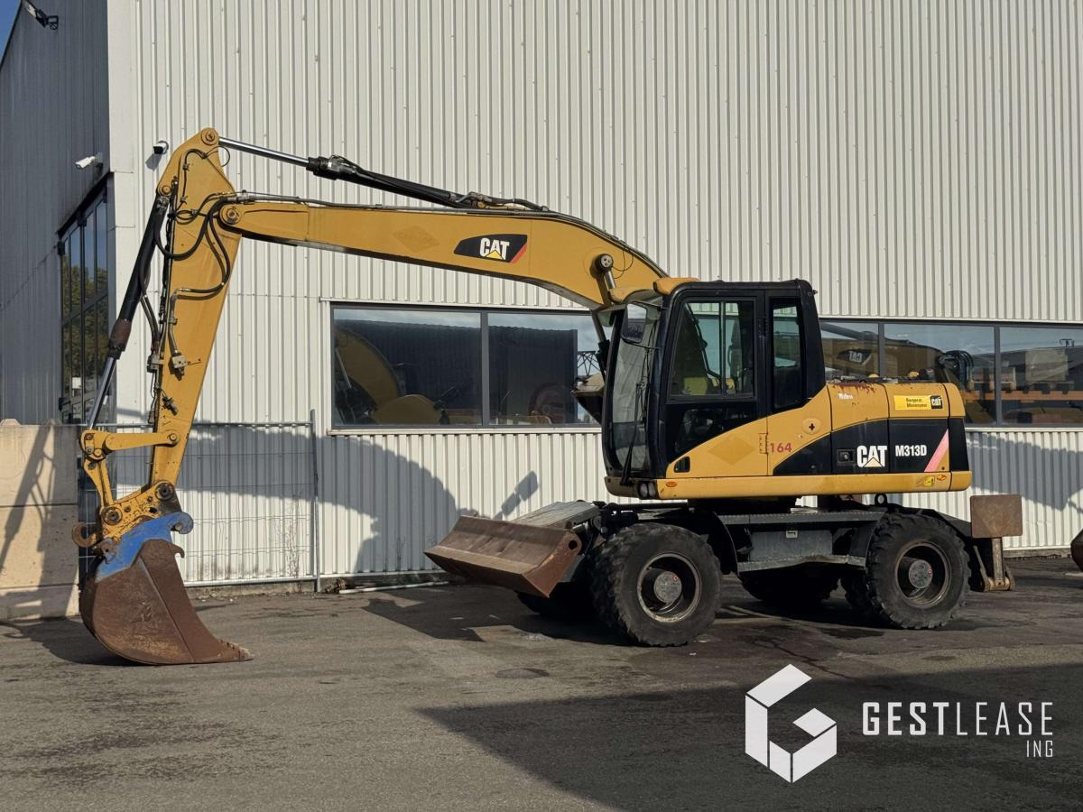 Caterpillar M313D - Pelle sur pneus: photos 1 Caterpillar M313D - Pelle sur pneus: photos 1