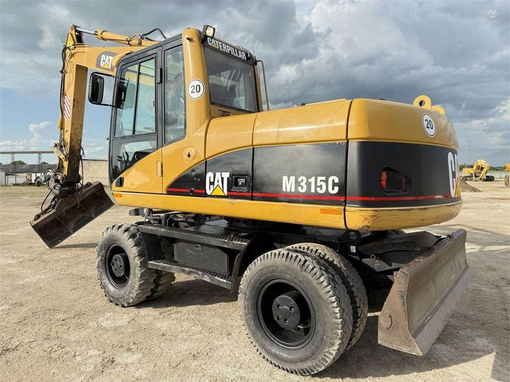 CAT M315C - Pelle sur pneus: photos 1 CAT M315C - Pelle sur pneus: photos 1