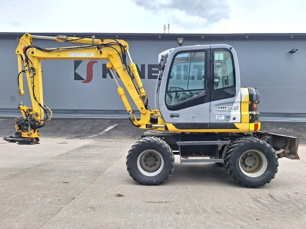 New Holland MH2.6 ENGCON PIHDEILLÄ - Pelle sur pneus: photos 1 New Holland MH2.6 ENGCON PIHDEILLÄ - Pelle sur pneus: photos 1