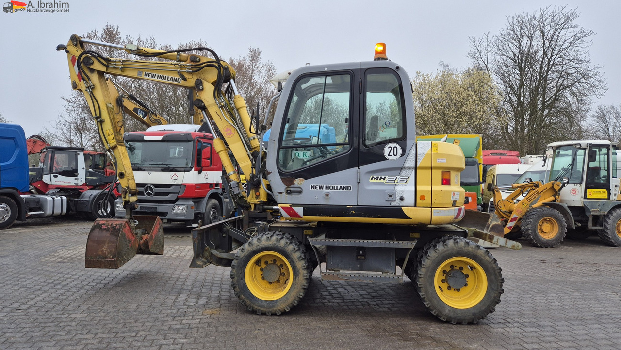 New Holland MH 2.6 Zustand gut, deutsche Maschine incl. Greifer und Dreservo - Pelle sur pneus: photos 1 New Holland MH 2.6 Zustand gut, deutsche Maschine incl. Greifer und Dreservo - Pelle sur pneus: photos 1