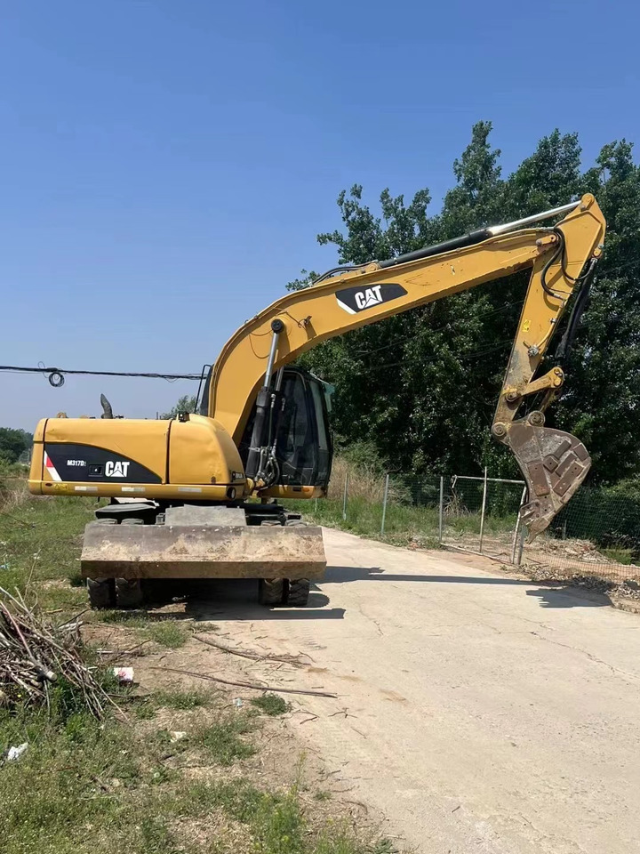 CATERPILLAR M317 - Pelle sur pneus: photos 1 CATERPILLAR M317 - Pelle sur pneus: photos 1