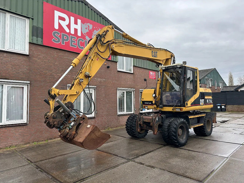 Caterpillar M315 +ROTO CE - Pelle sur pneus: photos 2 Caterpillar M315 +ROTO CE - Pelle sur pneus: photos 2